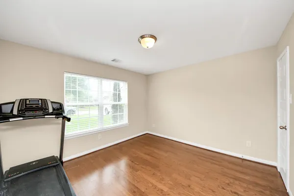 a view of a kitchen with wooden floor and a sink