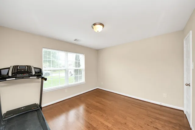 a view of a kitchen with wooden floor and a sink