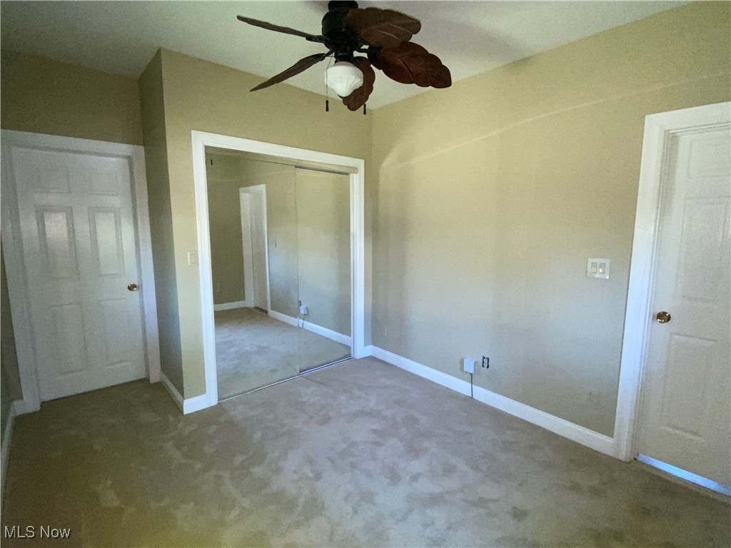 3016 Wadsworth Road Norton, OH 44203 - Photo 21 of 50 First floor bedroom with a closet, ceiling fan, and carpet