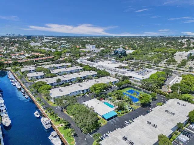 a view of a swimming pool with outdoor seating and plants