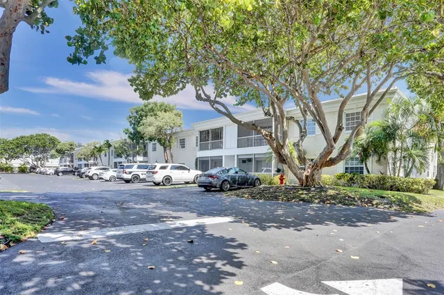 a view of a house with a tree in front