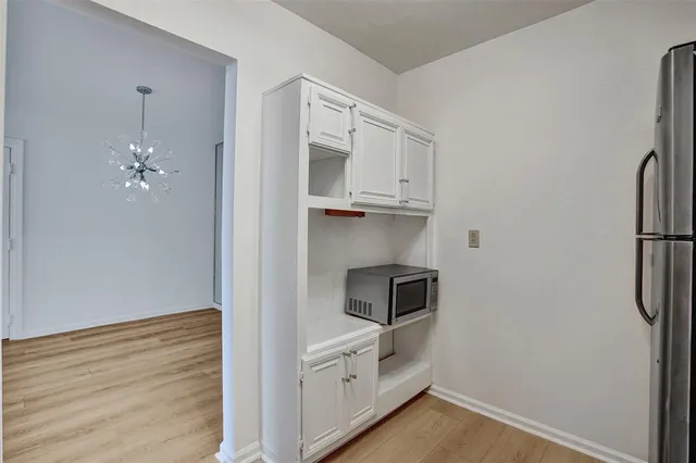 a dining room with furniture and a floor to ceiling window
