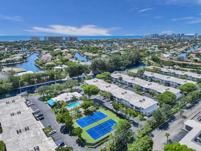 an aerial view of residential houses with outdoor space and river