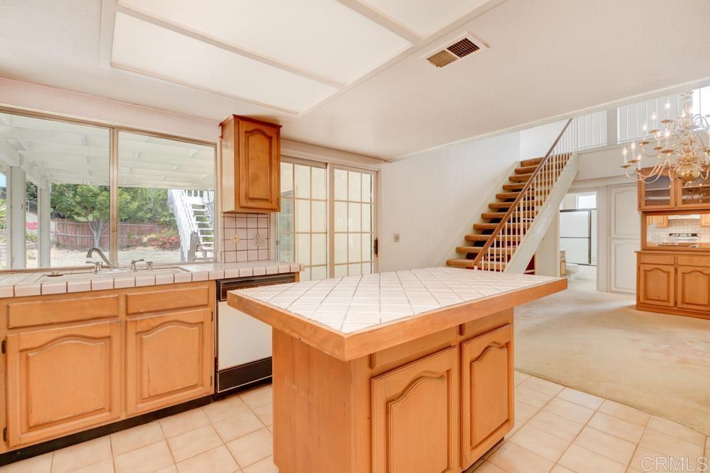 1706 Catalpa Road Carlsbad, CA 92011 - Photo 12 of 30 a kitchen that has a sink and a stove in it