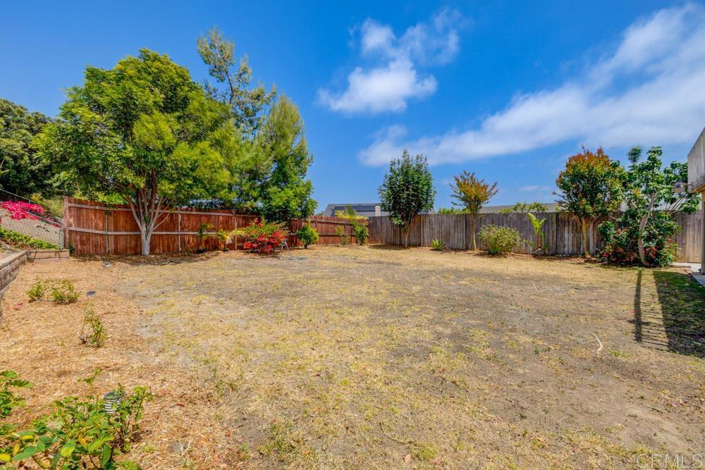 1706 Catalpa Road Carlsbad, CA 92011 - Photo 13 of 30 a backyard of a house with table and chairs