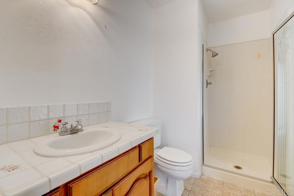 1706 Catalpa Road Carlsbad, CA 92011 - Photo 21 of 30 a bathroom with a sink toilet and shower