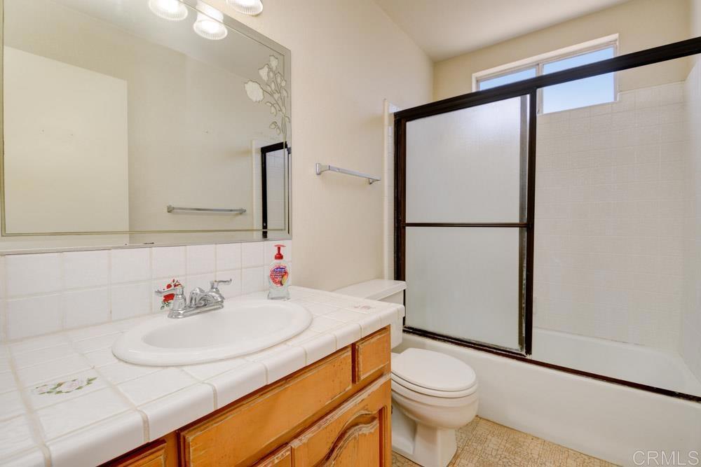 1706 Catalpa Road Carlsbad, CA 92011 - Photo 23 of 30 a bathroom with a sink toilet and mirror