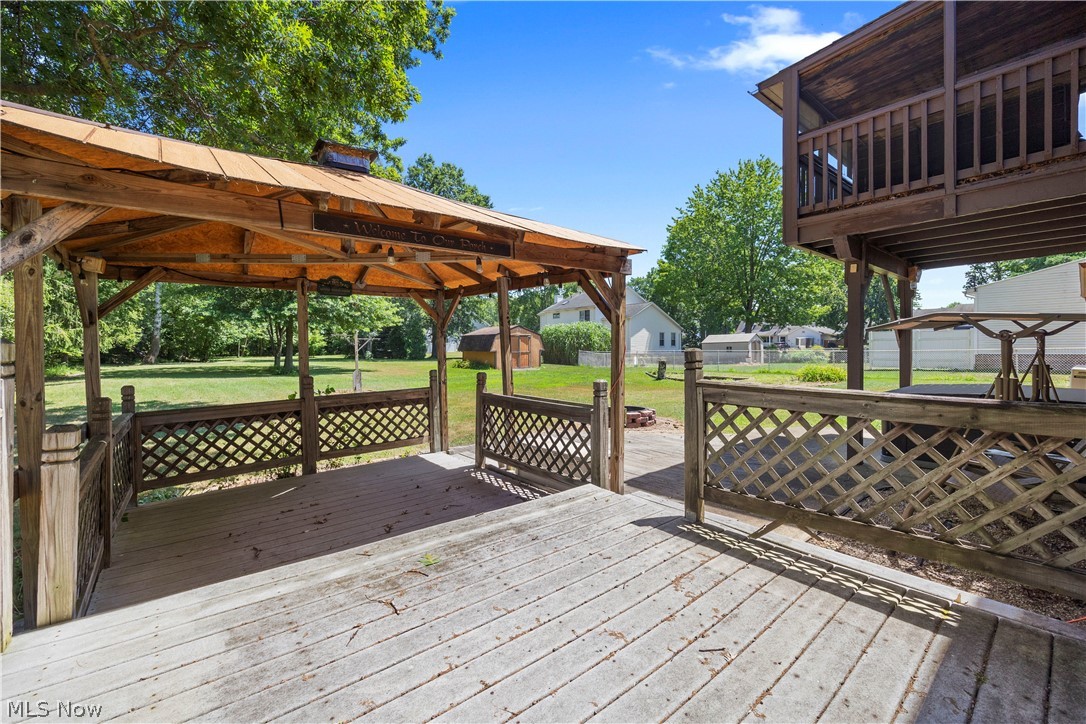 2565 Abbe Road North Sheffield Lake, OH 44054 - Photo 15 of 32 Wooden terrace featuring a storage shed and a lawn