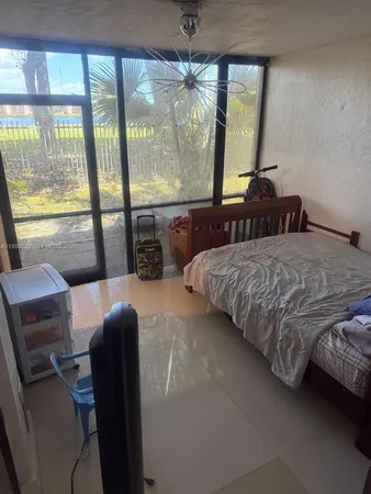 a bedroom with a large bed and a balcony view