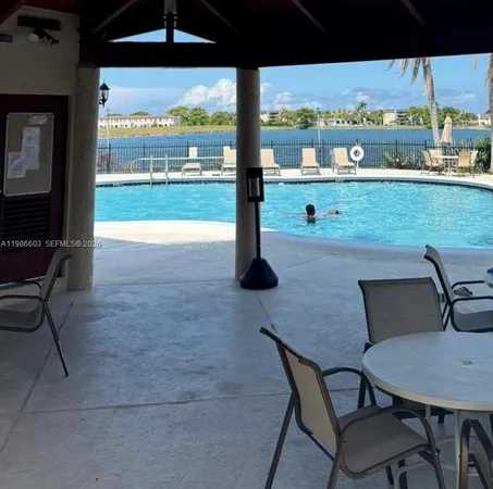 a view of a patio with lawn chairs