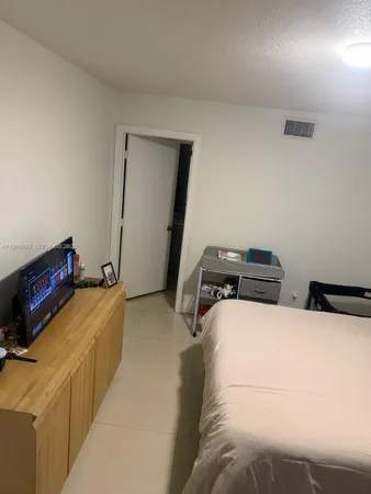 a bedroom with bed and cabinets