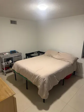 a bedroom with a bed and a desk