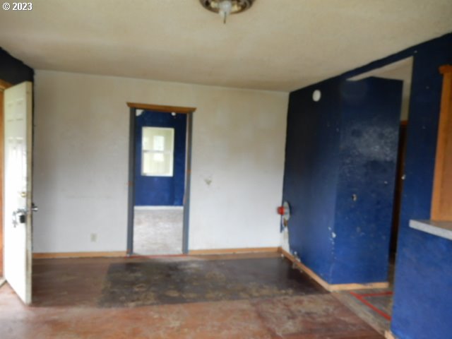411 East 3rd Avenue Riddle, OR 97469 - Photo 2 of 21 wooden floor and window in an empty room