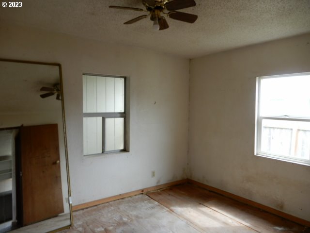 411 East 3rd Avenue Riddle, OR 97469 - Photo 8 of 21 an empty room with windows and closet