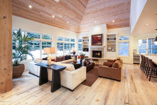 a living room with fireplace furniture and a wooden floor