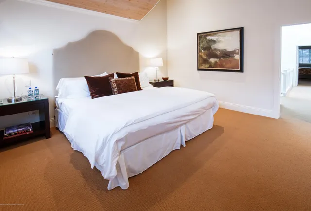 a bedroom with bed and lamp