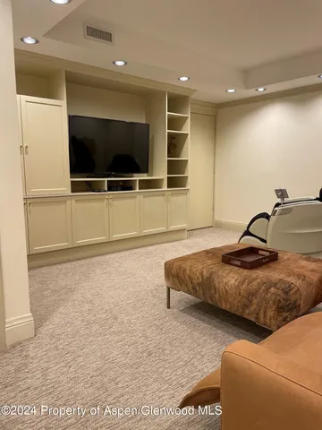 a living room with couches and a flat screen tv