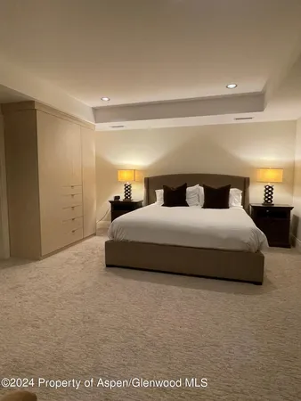 a bedroom with bed and a night stand