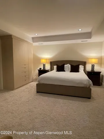 a bedroom with bed and a night stand