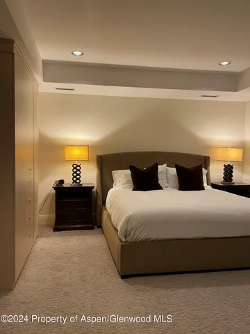 a bedroom with a bed and a night stand