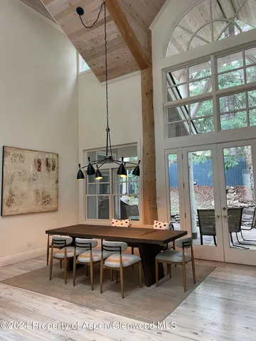 a dining room with furniture a rug and a large window