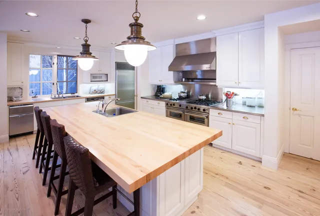 a kitchen with a stove a refrigerator and a dining table