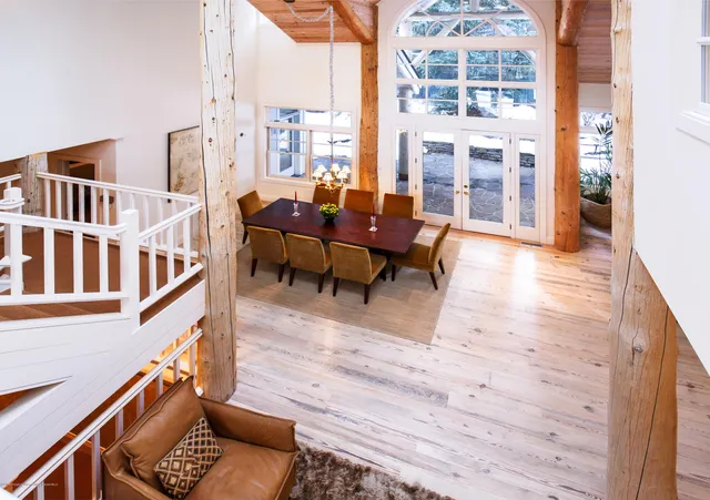 a living room with furniture wooden floor and a large window