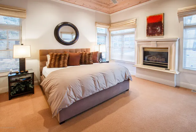 a bedroom with a bed and a fireplace