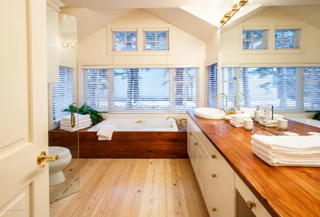 a spacious bathroom with a granite countertop tub and a sink