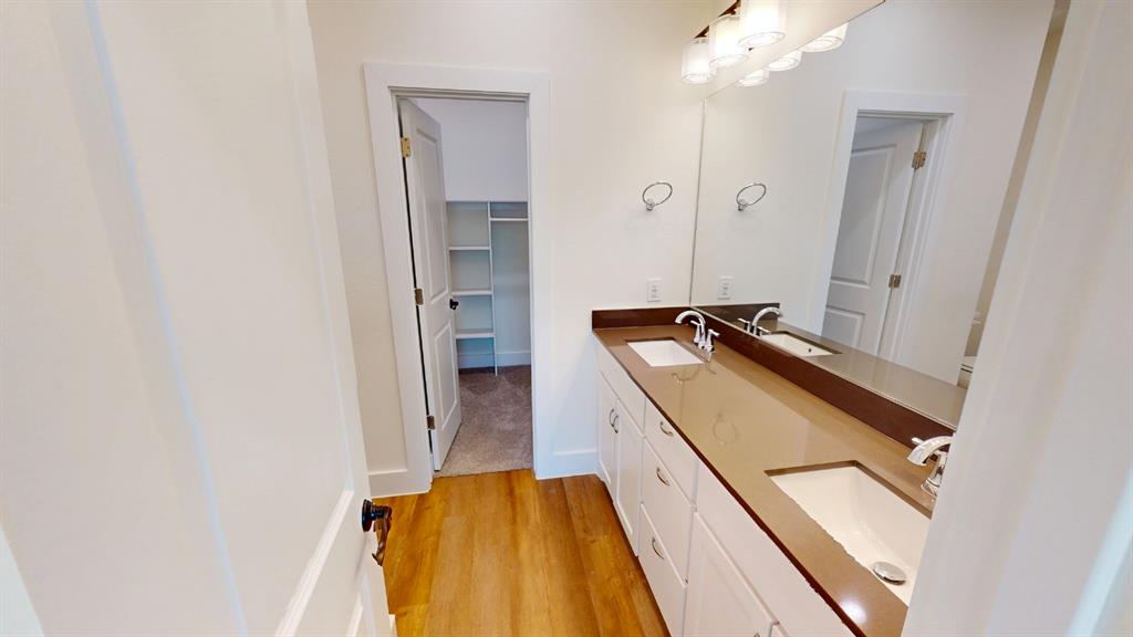 313 Buck Ridge Drive Frisco, TX 75068 - Photo 17 of 20 Dual vanity with integrated sinks, a wide mirror, and a contemporary light fixture