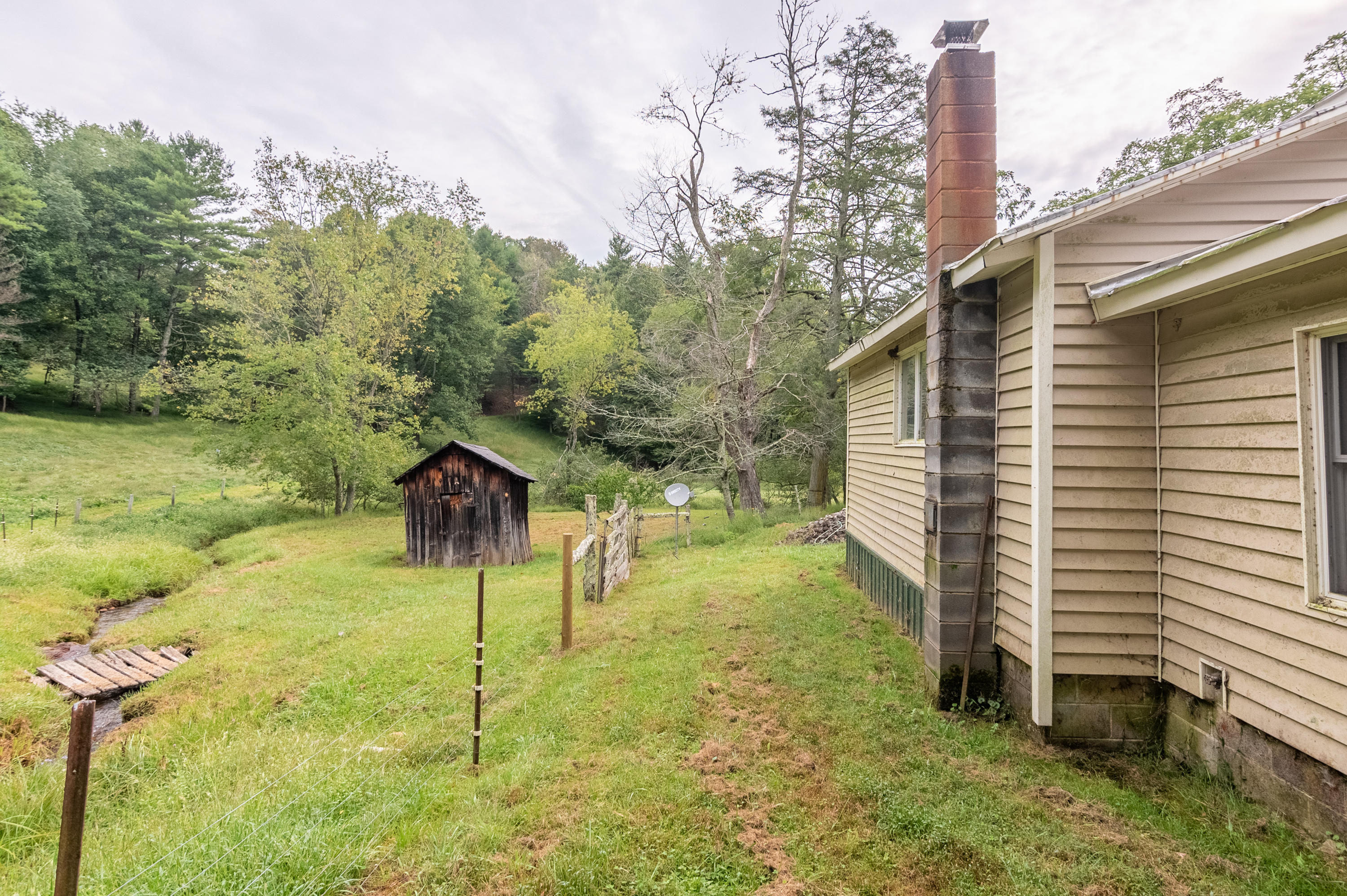 361 Wade Road Northwest Floyd, VA 24091 - Photo 15 of 48 a backyard of a house with table and chairs