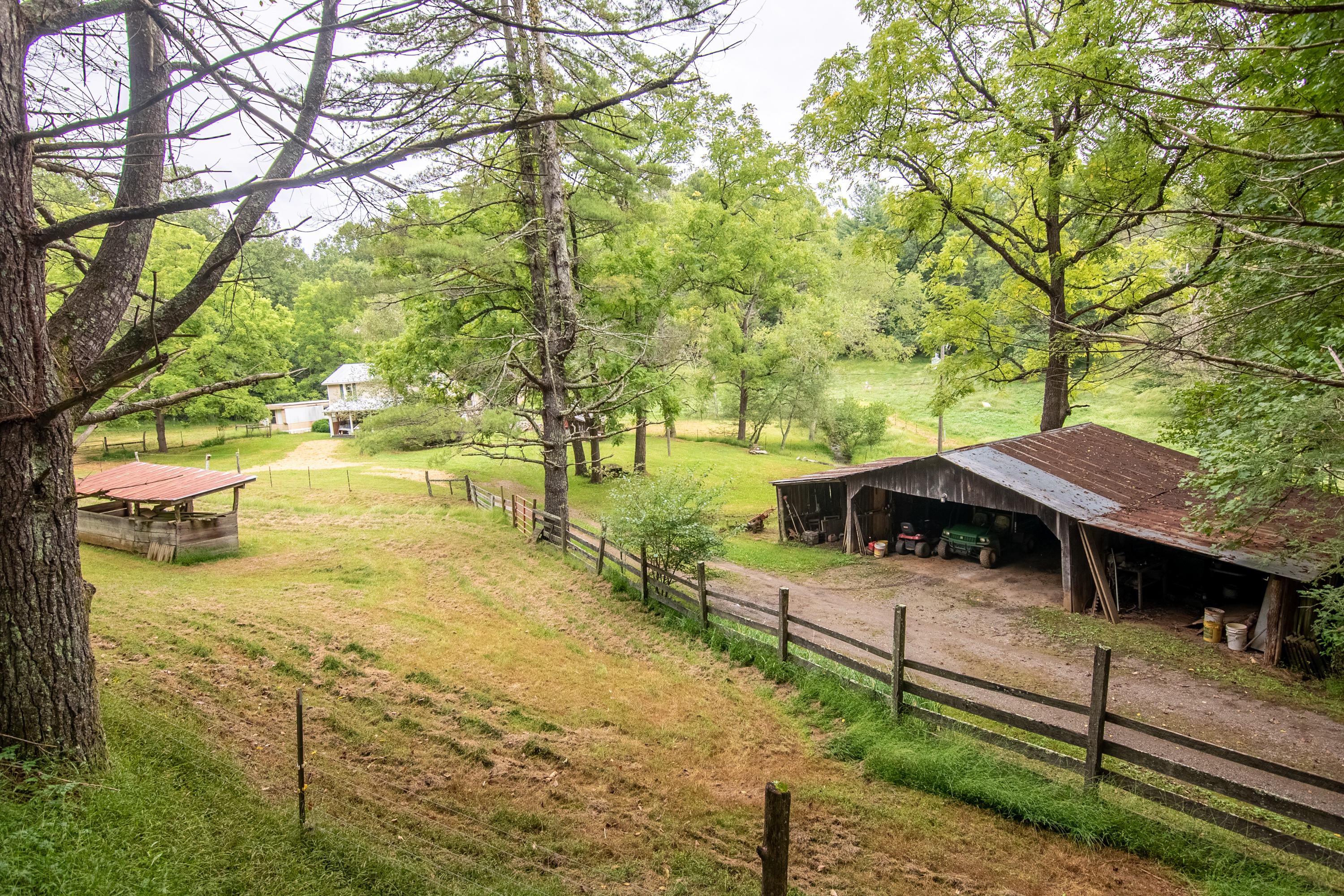 361 Wade Road Northwest Floyd, VA 24091 - Photo 33 of 48 a view of a patio with table and chairs under an large tree