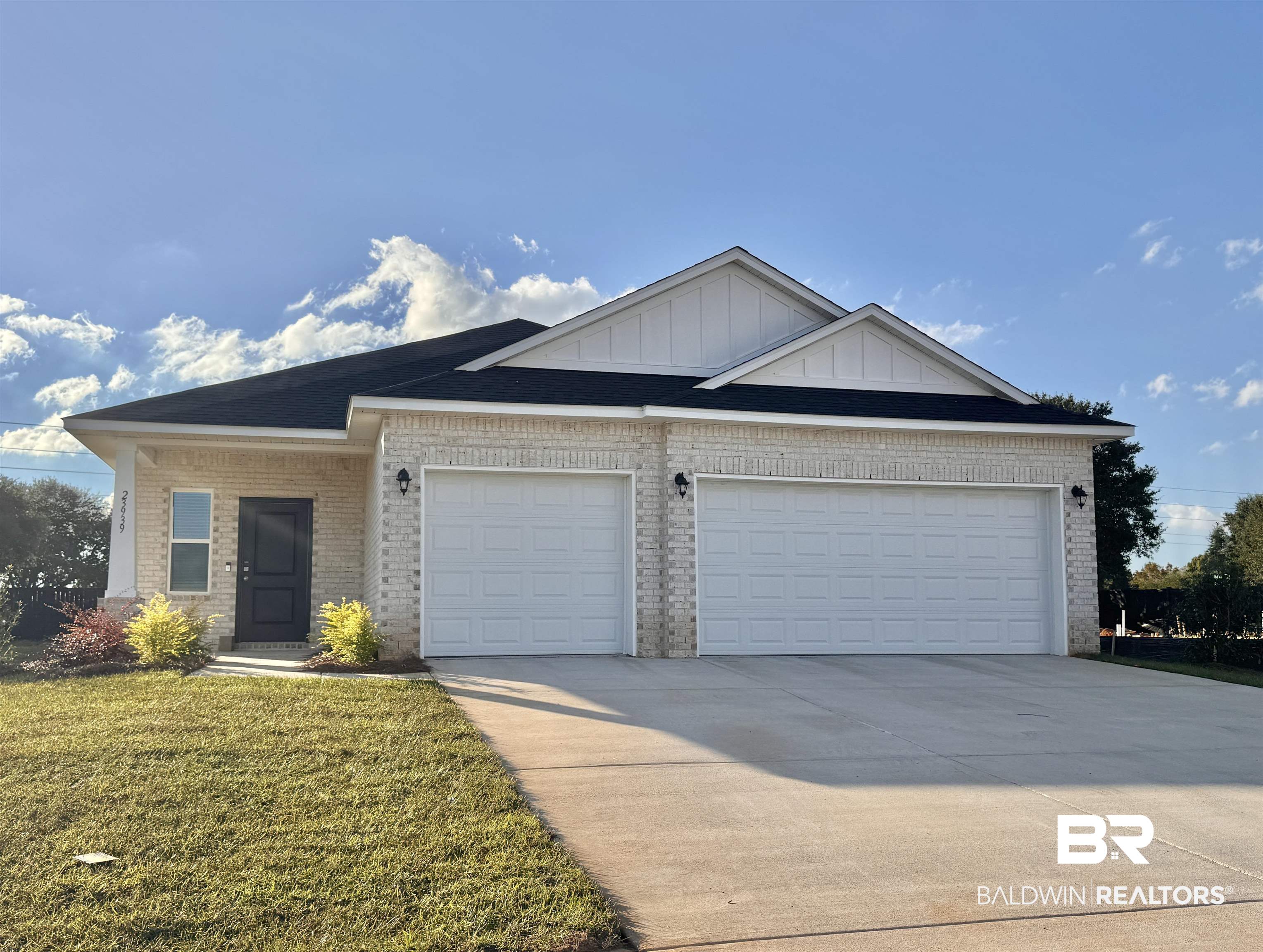 23939 Dominus Drive Daphne, AL 36526 - Photo 1 of 9 Ranch-style house with driveway, brick siding, a garage, and a front lawn