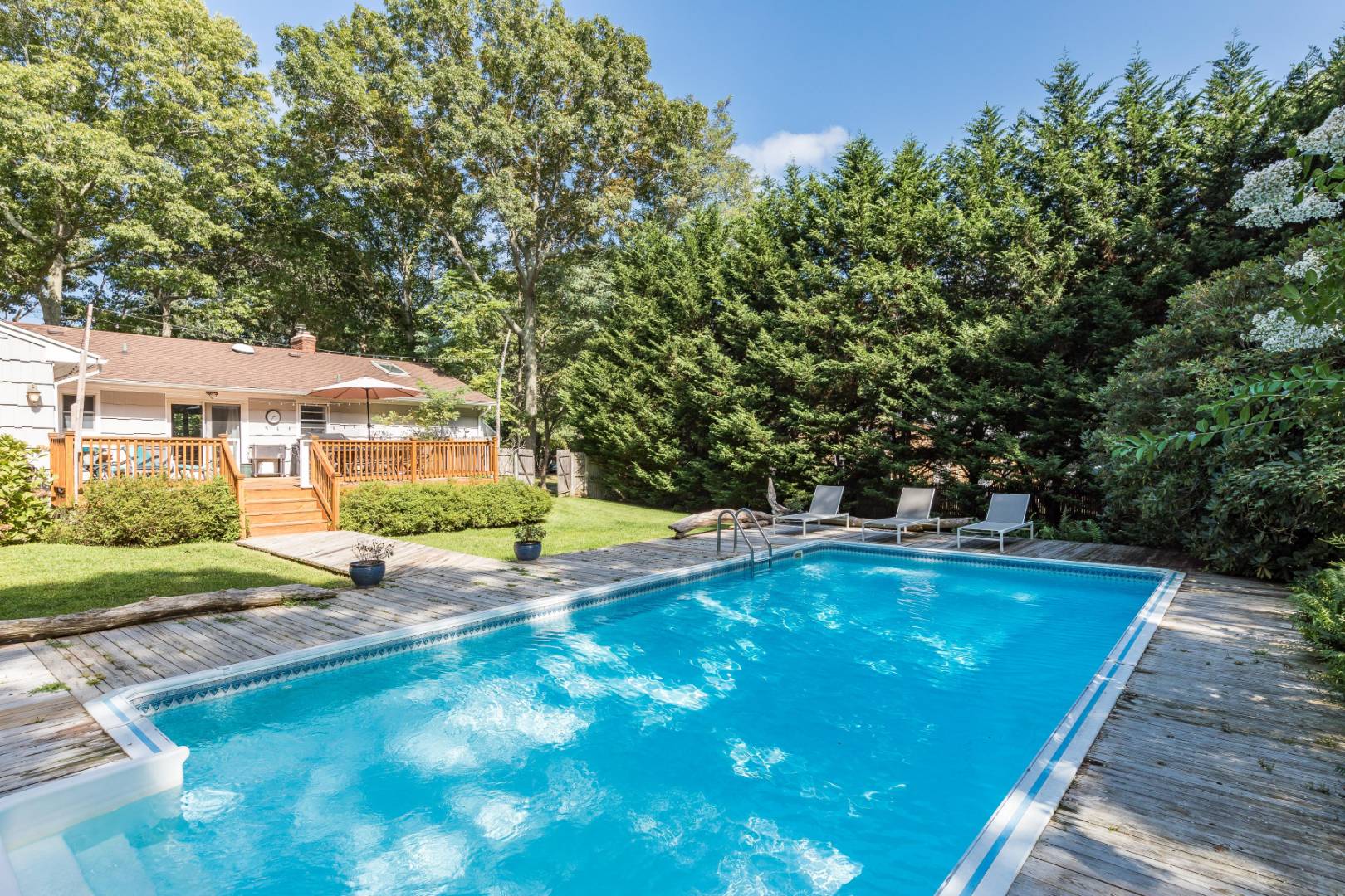 38 Glade Road East Hampton, NY 11937 - Photo 13 of 14 a view of swimming pool with lawn chairs and plants