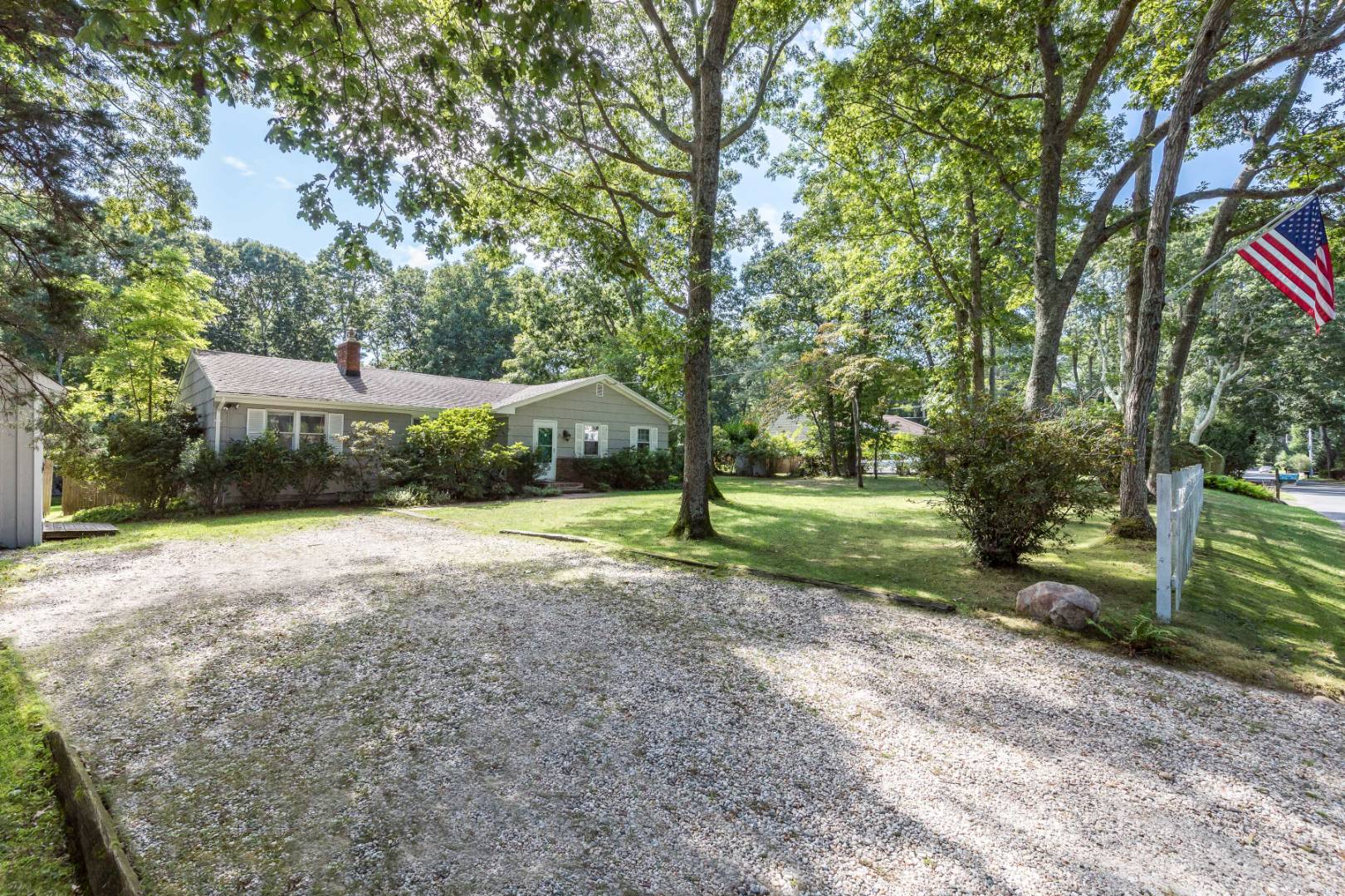 38 Glade Road East Hampton, NY 11937 - Photo 3 of 14 a front view of a house with a yard