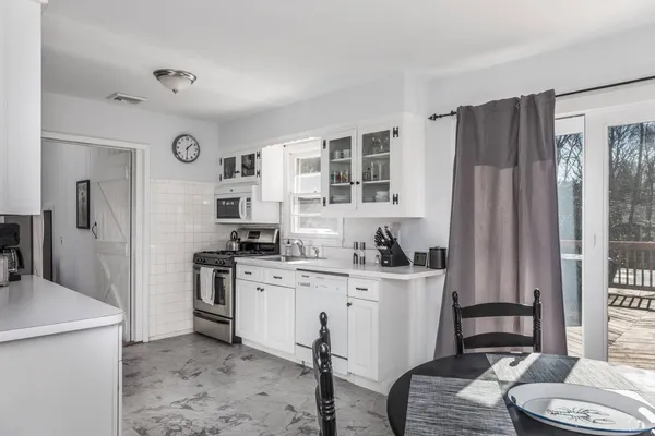 a kitchen with stainless steel appliances a stove a refrigerator and a refrigerator