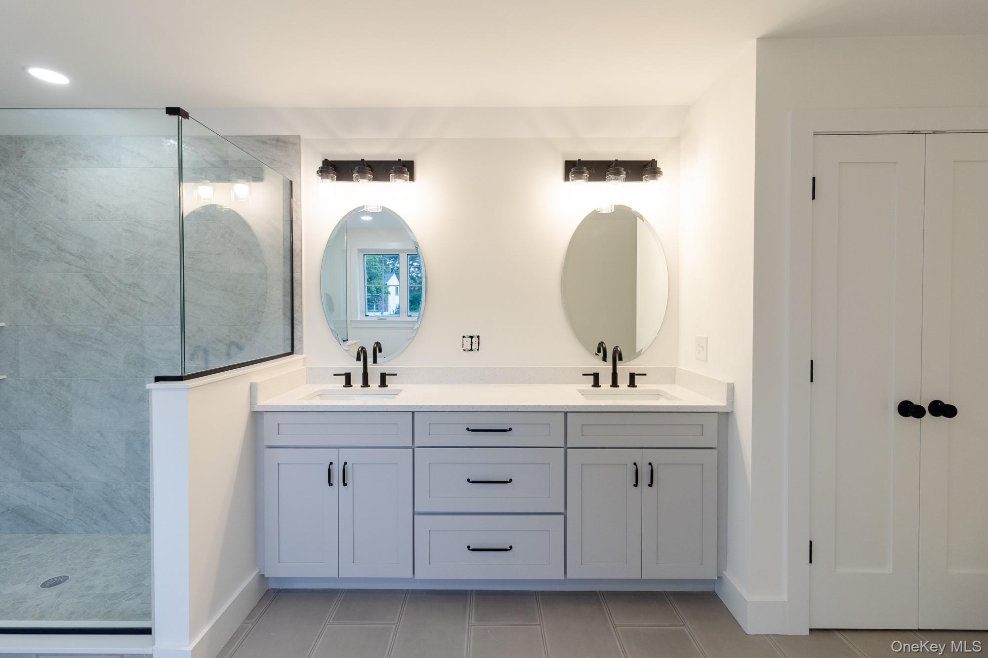 750 Ridgebury Road Slate Hill, NY 10973 - Photo 27 of 41 a bathroom with a double vanity sink and a mirror