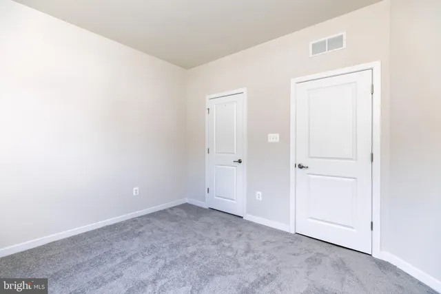 an empty room with closet area
