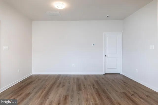 an empty room with wooden floor