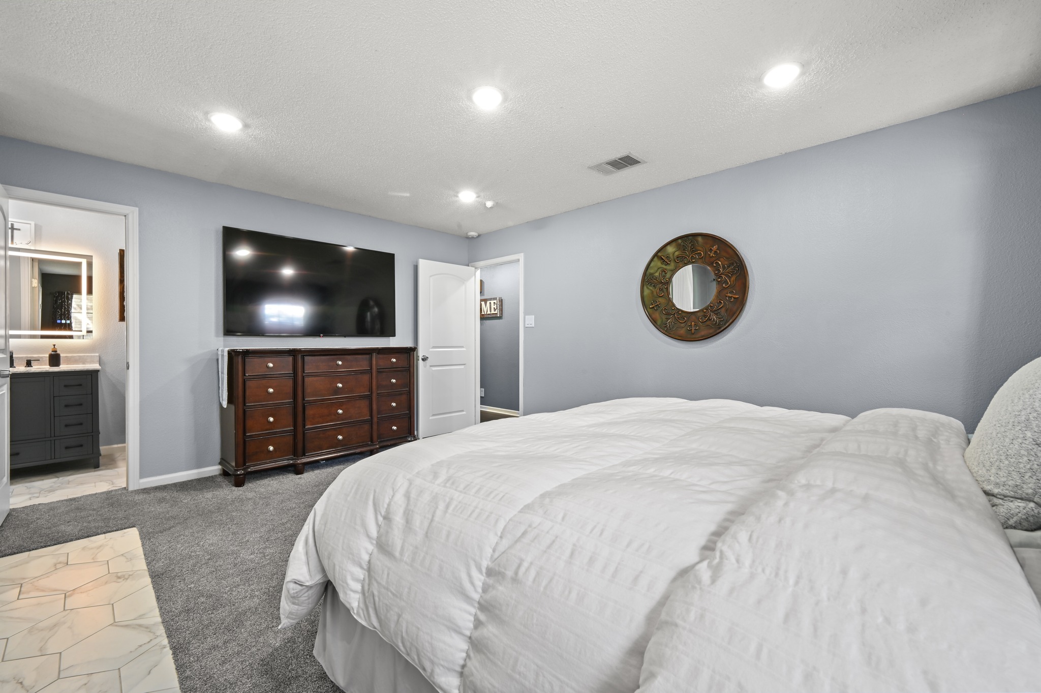 303 Pin Oak Drive Georgetown, TX 78628 - Photo 20 of 36 a bedroom with a bed and a flat screen tv