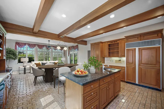 a kitchen with granite countertop cabinets stainless steel appliances a sink and a large window