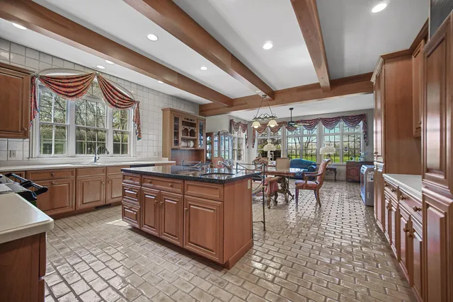 a dining room with furniture a rug and a large window