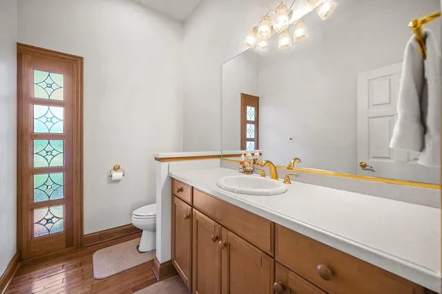 a view of staircase with lots of frames on wall and a large window