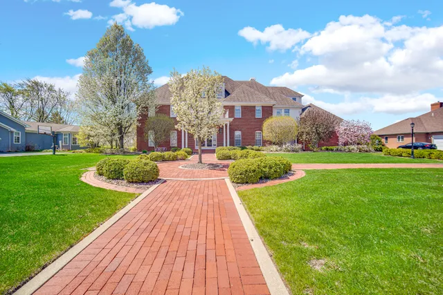 a view of a big building with a big yard and plants