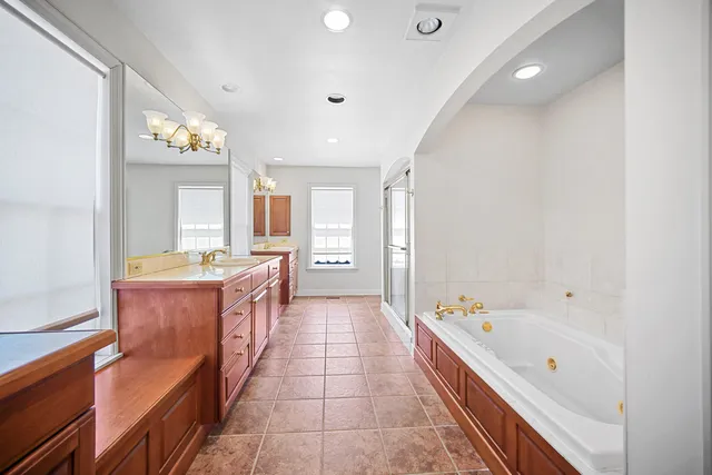 a bathroom with a sink a mirror and a shower