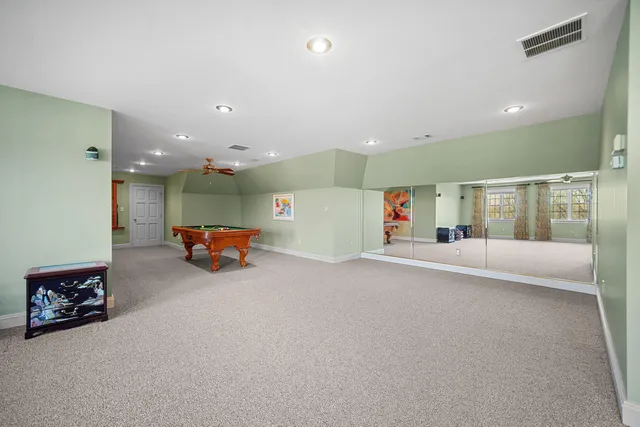 a bathroom with a double vanity sink a toilet and a mirror