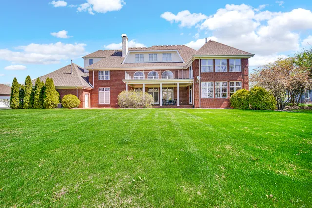 a view of a big house with a big yard and potted plants