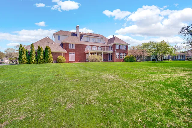 an aerial view of a house with garden space and outdoor seating