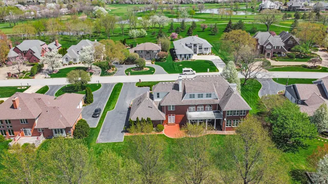 an aerial view of a house with swimming pool and yard