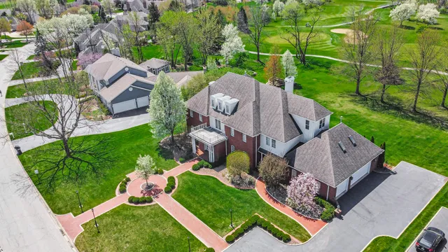 a aerial view of a house with garden and a sitting area